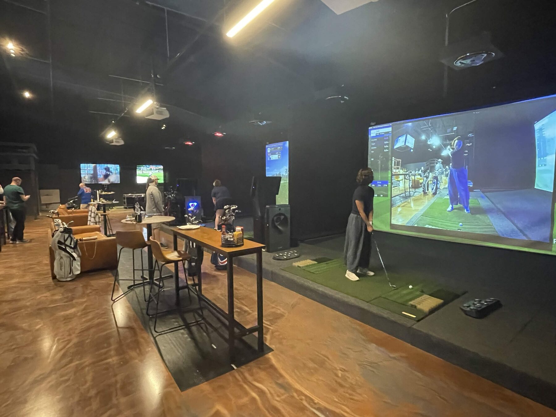 Pin Seeker Indoor Golf & Sports Grill venue with simulator bays and sports screens